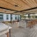covered grilling area with seating and tables