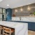community kitchen with seating table and windows