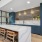 community kitchen with seating table and windows